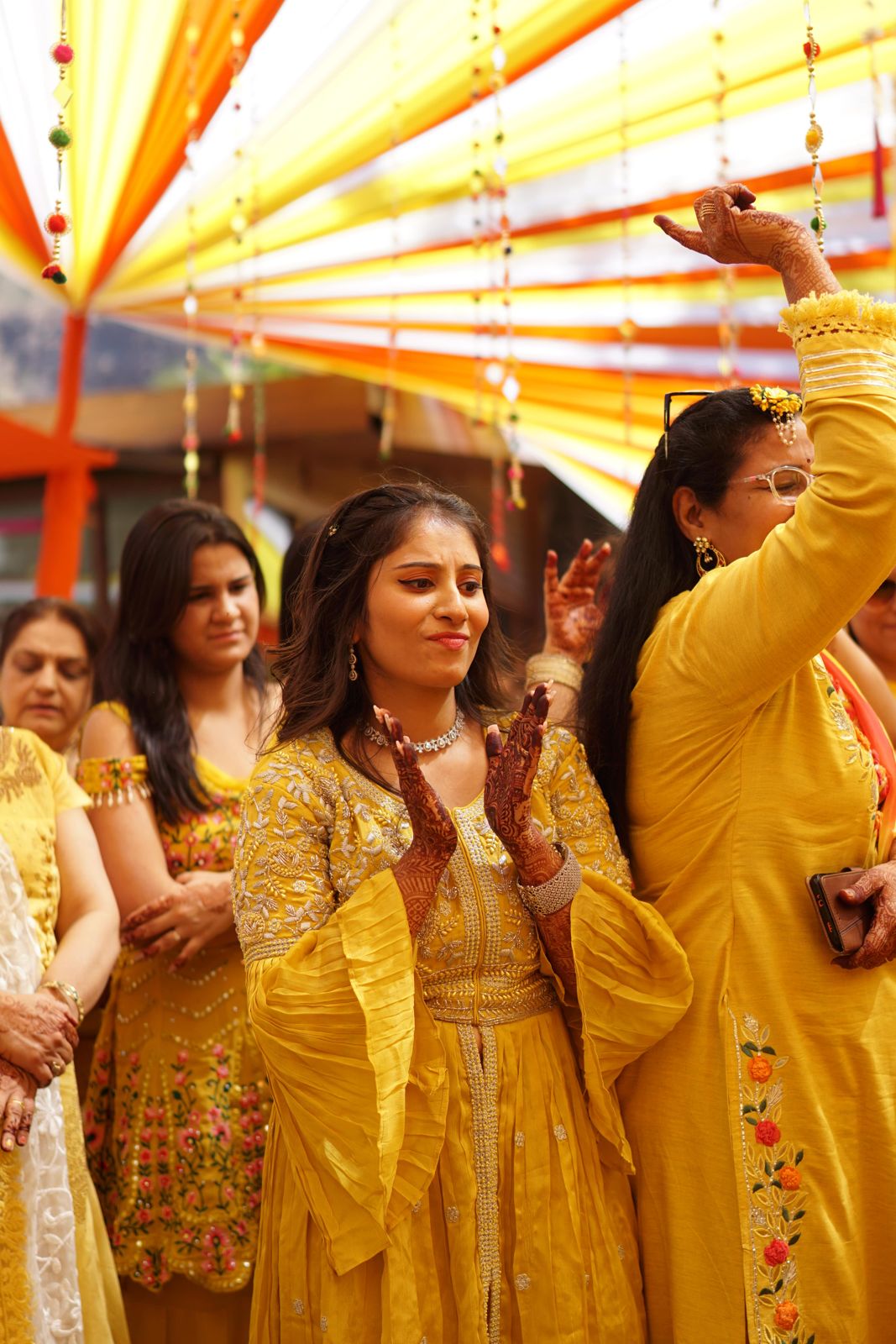 Family dancing at a yellow haldi ceremony